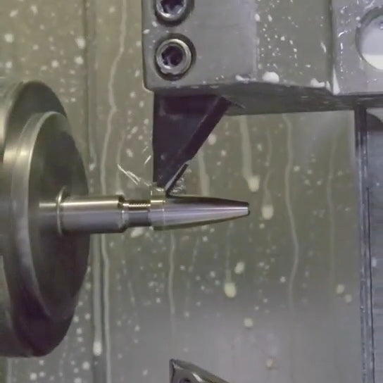 Metal pen component being machined