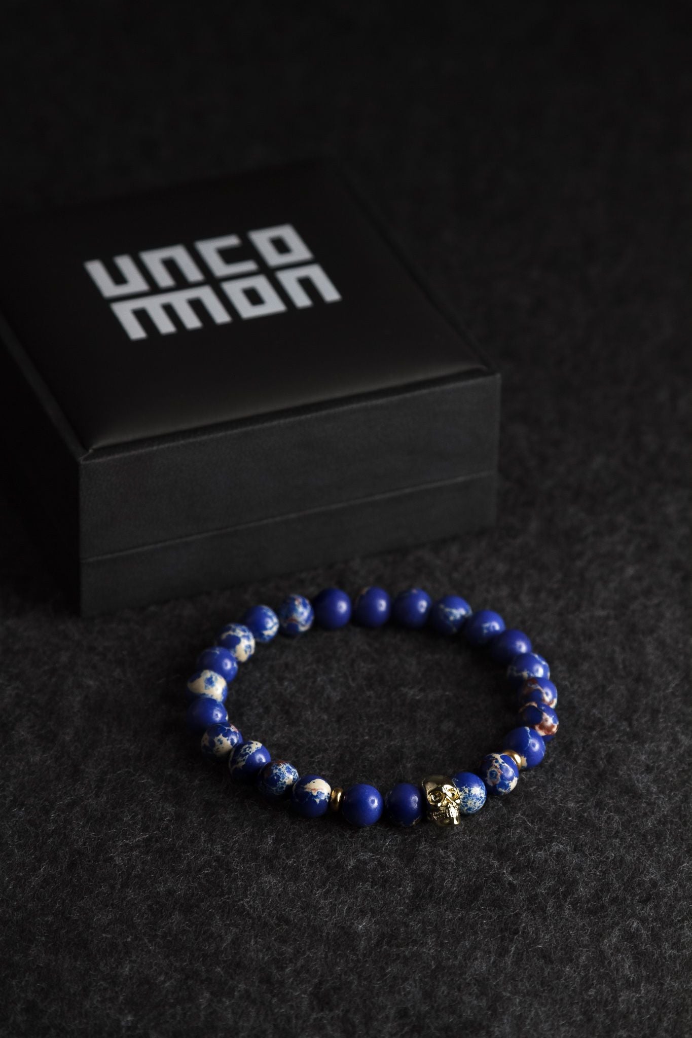 UNCOMMON Men's Beads Bracelet One Gold Skull Charm Blue Jasper Beads
